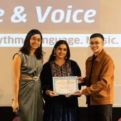Celebrating a milestone. A participant receives her certificate of completion at the 'Verse & Voice' performance showcase. We believe in recognizing your hard work and providing credentials that strengthen your creative resume.