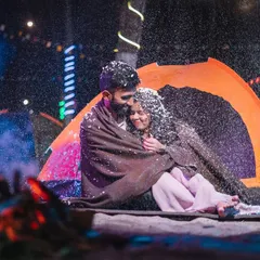 A magical moment during a night camping theme. We used artificial snow to create this cozy, winter-wonderland feeling, even next to a warm bonfire.