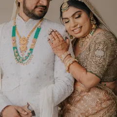 A tender moment between Mahesh and Laxmi. The bride rests her head on the groom's shoulder, a simple gesture that speaks volumes about their bond.