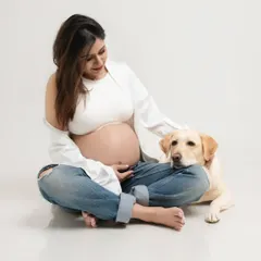 A girl and her dog. This simple, beautiful portrait shows the deep bond between the mother-to-be and her first baby, her loyal fur companion.