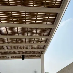 The beauty is in the details. This is a close-up of our handmade woven bamboo pergola, which provides beautiful, dappled shade and adds a unique, natural texture to your outdoor space.