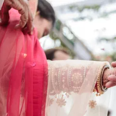 A close-up of the 'Gathbandhan' ritual, where the bride's and groom's garments are tied together. This symbolic act represents their eternal bond, and I capture it with artistic detail.