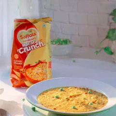 A bright and airy lifestyle shot of Saffola Masala Oats, prepared in a bowl to look like a delicious and healthy meal.