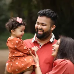 A moment of genuine laughter and connection between parents and their child. Outdoor sessions allow for this kind of spontaneous and natural interaction.