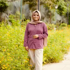 Standing in a field of flowers, feeling grateful for my journey. My goal is to help every woman feel this confident and happy in her own skin.