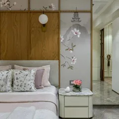 A serene bedroom where our custom Chinoiserie wallpaper is used as paneled art behind the bed. The delicate cherry blossoms and soaring bird create a peaceful, artistic focal point that complements the room's soft, elegant palette.