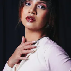 A classic portrait pose that showcases the outfit's neckline and the model's confident look. The lighting is focused to highlight her features and the texture of the fabric.