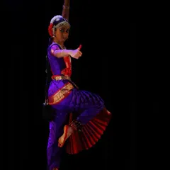 This dynamic pose, captured during Sahana's Arangetram, showcases the strength and precision required in classical dance, a result of years of patient practice.