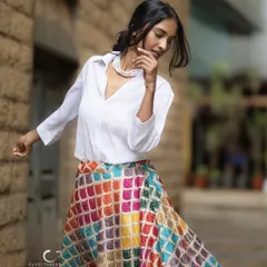 Capturing movement and grace in an urban alley. The swirl of her colorful skirt against the stone wall creates a beautiful contrast, telling a story of vibrant life in the city.