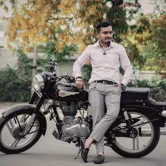 A classic pose with a Royal Enfield motorcycle. These bikes add a cool, timeless vibe to outdoor and pre-wedding photography sessions.