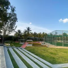 A ground-level view of the amphitheater and event lawn at Vaishnavi Tech Square. The stepped seating provides a natural gathering spot with views of the surrounding landscape.