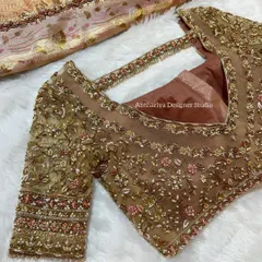 This blouse combines a solid V-neck lining with a fully embroidered sheer overlay. The modern cut and delicate handwork make it a versatile piece for receptions and parties.