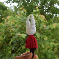 A back view of the Hornet doll, highlighting the clean stitch work on the head and the shape of the cloak. Every detail is handcrafted with care.