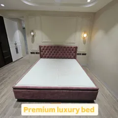 A premium luxury bed with a deep-buttoned, tufted headboard in a beautiful mauve velvet. This king-size bed also features hydraulic storage, combining elegance with functionality.