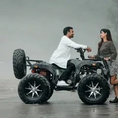 A candid and happy moment during an ATV shoot. The couple's interaction with the vehicle adds a fun and dynamic element to their photos.