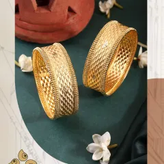Shine bright with our stunning new bangle collection. The quilted pattern on these broad gold bangles adds a modern texture to a classic design.