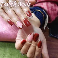 A modern design featuring deep red polish paired with accent nails that have a geometric pink section outlined in silver glitter.