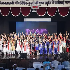 All hands up for a spectacular finish. The energy of the full IMAD team on stage is electric, marking the culmination of months of hard work and passion.