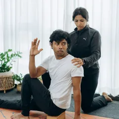 A simple yoga block can transform a pose. Here, we use it to provide lift in a seated twist, which helps maintain a long spine and allows for a deeper, safer rotation.