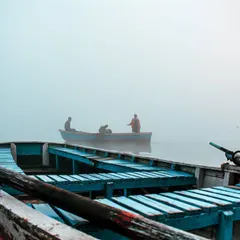 I took this shot from inside one boat, looking out towards another. This perspective gives a sense of being right there on the water, part of the quiet morning ritual.