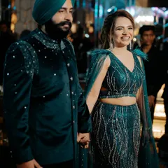 A happy couple making their grand entrance. Her smile and glowing makeup light up the frame.