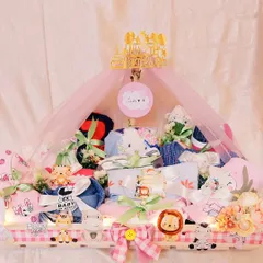 This stunning baby hamper was created for a little one's first birthday. It's a trousseau filled with adorable outfits and toys, all presented in a beautifully decorated animal-themed crate.