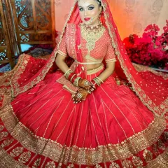 A full-length view of a traditional red bridal lehenga look. Notice how the makeup complements the entire outfit, creating a cohesive and royal appearance that I teach my students to achieve.