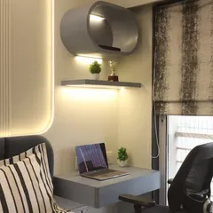 A compact work-from-home corner integrated into a master bedroom. The floating desk and curved overhead shelf provide a functional workspace without taking up valuable floor area, complemented by integrated LED lighting.