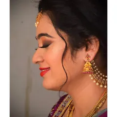A side profile showing the soft contour and the beautifully blended eyeshadow. This elegant South Indian engagement makeup is perfect for capturing timeless photos.