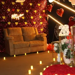 This romantic setup features a candle-lit path, a heart made of rose petals, and a sparkling backdrop. It's the perfect ambiance for an anniversary or a birthday celebration for your special someone.
