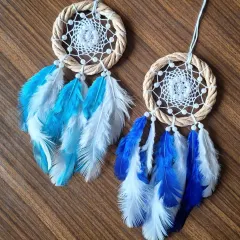 Serenity in motion. This pair of blue and white feathered dreamcatchers was crafted to keep your vibes in check while you chase your dreams on the road.