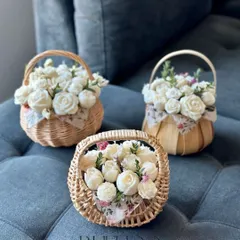 Our flower bouquet baskets are perfect for gifting or decorating your own space. These charming wicker baskets are filled with small, rose-shaped candles.
