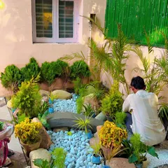 Here I am giving the final touches to a Zen garden installation. Every element is placed carefully by hand to achieve a balanced and natural look, perfect for a quiet corner of a home or office.