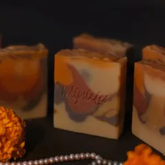 A close-up of our Noor Santhal soap, crafted especially for the 'pahili anghol' Diwali bath. It features a blend of Sandalwood, Rose, and Frankincense, with natural clays for color, embodying the spirit of heritage and ritual.