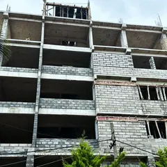 The Hosa Road commercial project in its early construction phase. This image shows the bare concrete frame and the beginning of the blockwork, the essential first steps in bringing the architectural vision to life.