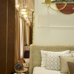 The reflection in the mirrored wardrobe panel shows a glimpse of the dressing area, a clever way to make the room feel larger and more connected.