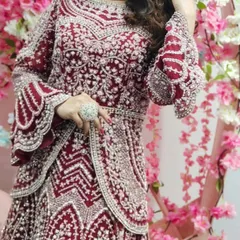 This Pakistani-style peplum jacket and lehenga set is a masterpiece. The heavy silver embroidery and bell sleeves make it a truly unique and high-fashion bridal choice.