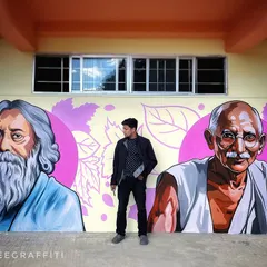 Standing in front of my portraits of Rabindranath Tagore and Mahatma Gandhi. Part of the 100-foot mural in Ziro, these pieces were painted with great respect to honor their contributions.