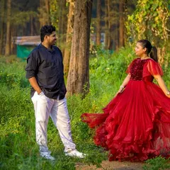 A perfect twirl in our flowy red gown. This outfit is lightweight and easy to move in, making it ideal for dynamic and romantic pre-wedding photoshoots in an outdoor setting.