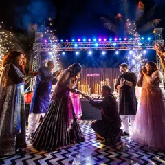 A romantic proposal on the dance floor. We help script these surprise moments, complete with stage effects, to make your Sangeet night even more special.