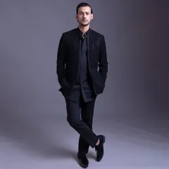 A full-length view of the open designer bandhgala, showcasing its sleek, modern silhouette. Paired with sharp trousers and dress shoes, it’s a perfect ensemble for a cocktail party or reception.