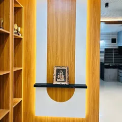 A wooden partition that cleverly divides a space without blocking light or views. This unit features a mix of wood and white panels with backlighting and includes a small shelf for decorative items.