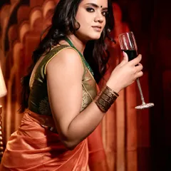 This indoor shot for a saree brand uses warm, dramatic lighting to create a regal and luxurious feel, highlighting the sheen of the silk fabric.