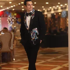 This client wanted something unique. I designed this black tuxedo with hand-painted artwork of a horse on the lapel and jacket, creating a wearable piece of art that’s both personal and stylish.