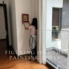 The final styling stage is where a house truly becomes a home. Here, I am carefully placing artwork in a primary bedroom at a Prestige Golfshire villa, ensuring each piece contributes to the room's serene and personal atmosphere.