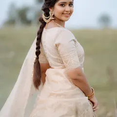 A beautiful portrait showcasing a soft, romantic side braid. The loose, face-framing pieces and the simple braid create an effortlessly chic look, perfect for a pre-wedding shoot.
