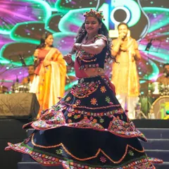Caught in a moment of dance during a Navratri celebration. The intricate details and vibrant colors of the chaniya choli are on full display.