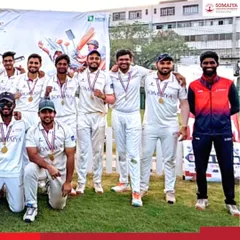 Another angle of the victorious K J Somaiya Institute of Management cricket team and their coach, celebrating a well-deserved championship win at the Lakshya 2026 tournament.