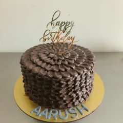 The full view of this beautifully textured chocolate birthday cake.