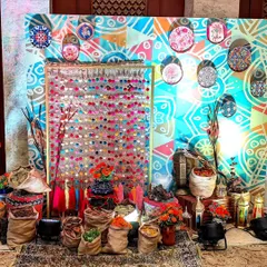 I created this eclectic photo corner inspired by a Turkish spice market. With colorful textiles, burlap sacks, and patterned plates, it provided a unique and interactive backdrop for guests.